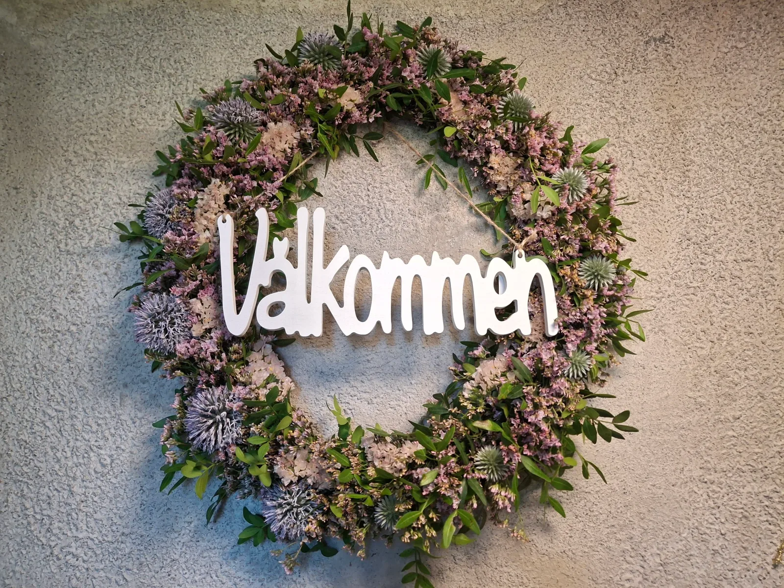 Krans med texten Välkommen